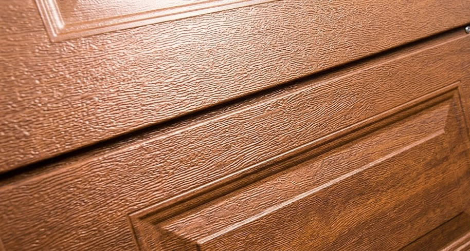 Textured garage door panel in a warm architectural colour